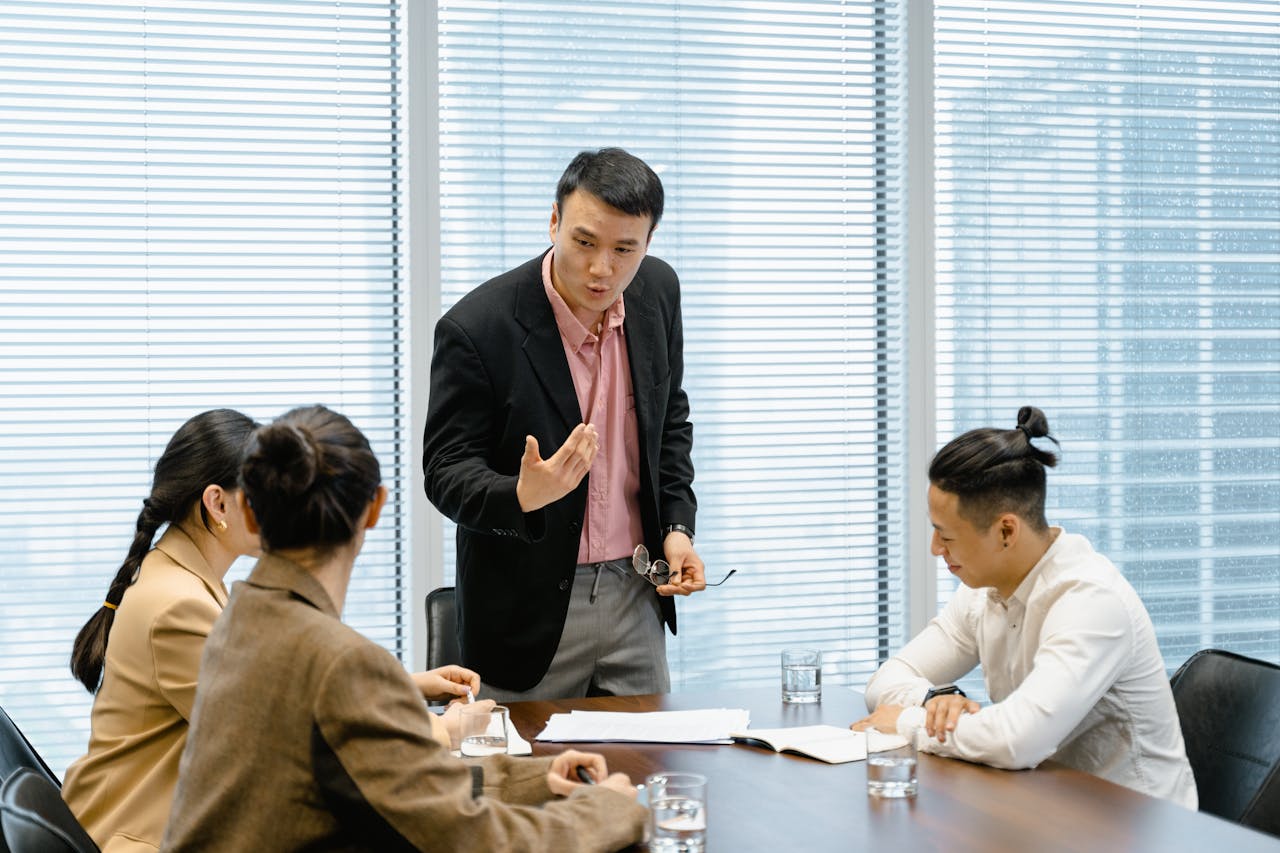 portfolio-01 A group of professionals engaged in a business meeting in a modern office setting.